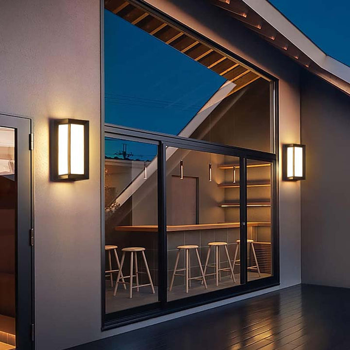 Modern interior with glass wall, stools, and wall lights.