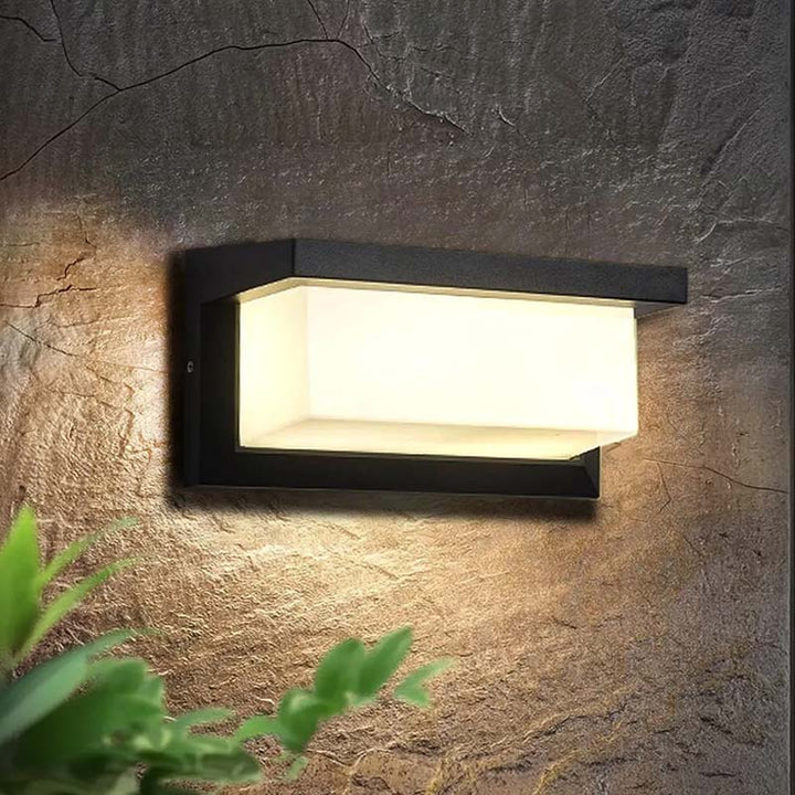 Motion Sensor Wall Light on garden wall – black aluminum LED lamp providing warm white security illumination