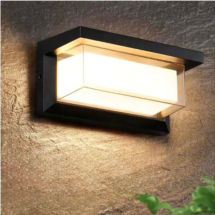 Outdoor wall light with modern black frame and warm LED glow, waterproof design for outdoor garden or porch lighting