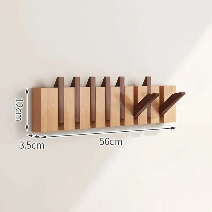Wooden wall-mounted coat rack with dimensions indicated on a plain background