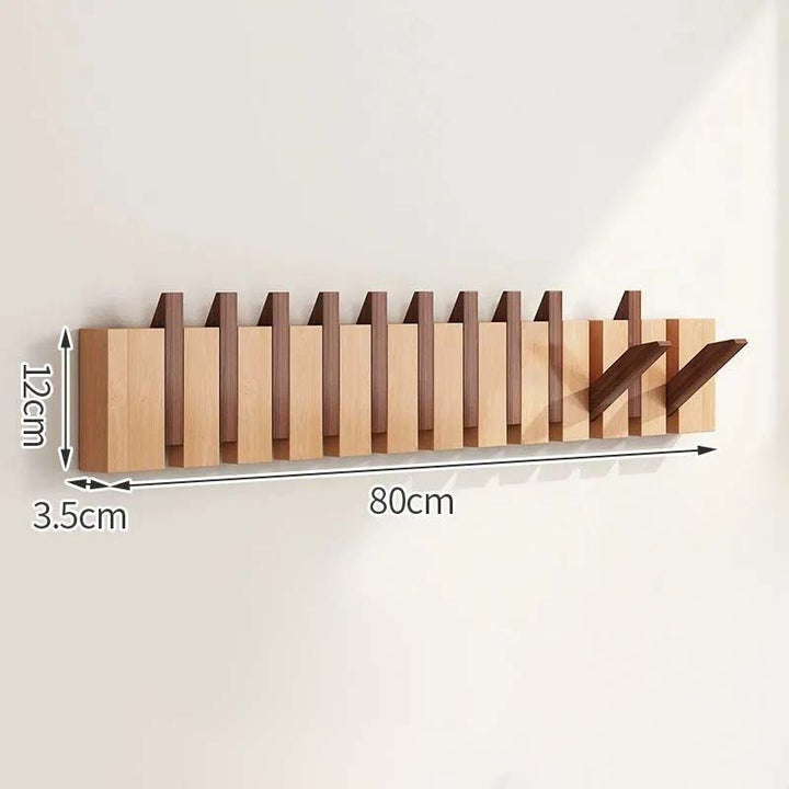 Wooden wall-mounted coat rack with dimensions on a white background