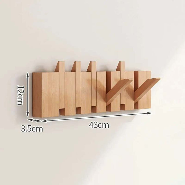 Wooden wall-mounted coat rack with dimensions indicated on a plain background