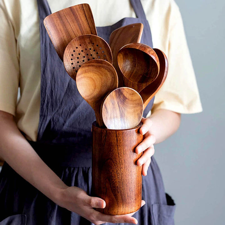 Scandinavian teak kitchen utensil set in holder, includes spoons and spatulas, eco-friendly cooking tools