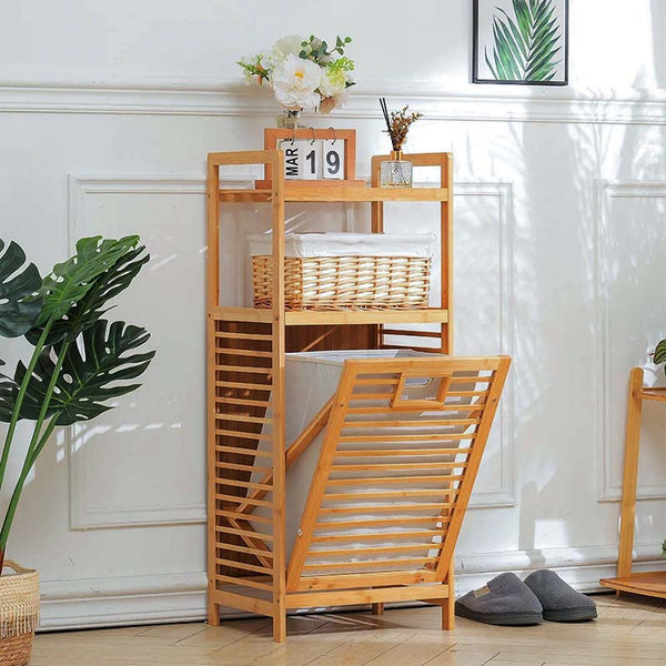 Wooden laundry basket with a ladder in a room with plants and a white wall.