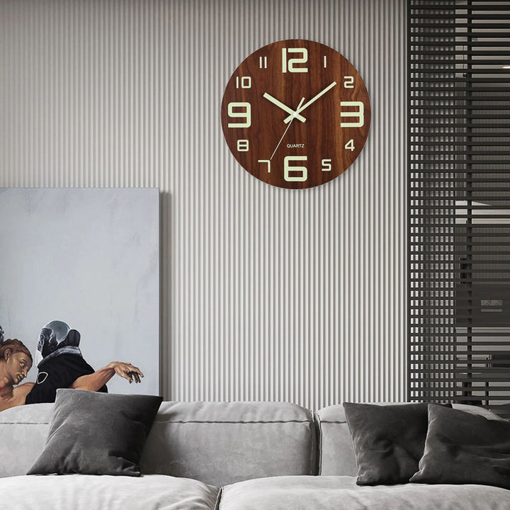 Wooden wall clock on a wall above a sofa with decorative pillows
