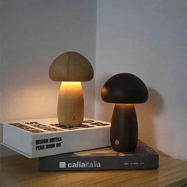 Pair of TRAESVAMP wooden mushroom lights, large and small, styled on a bedside table.