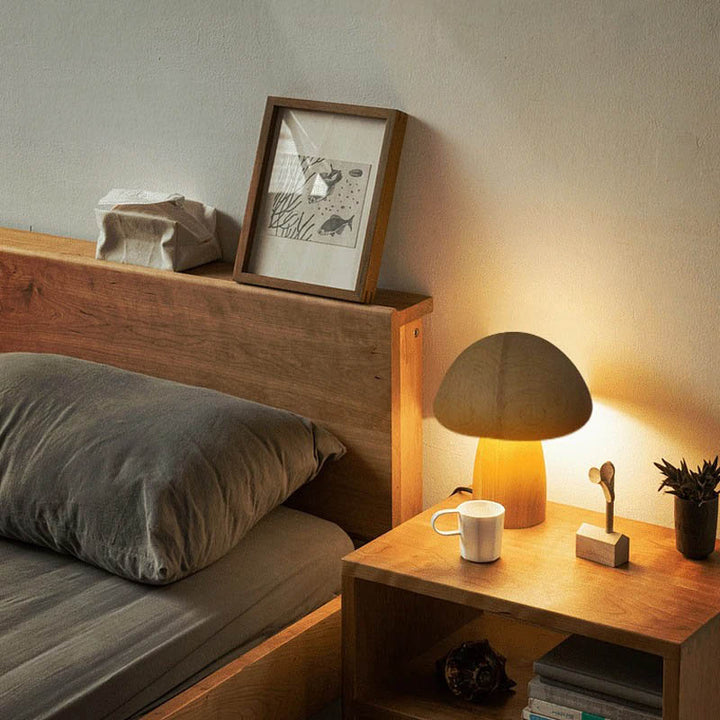 TRAESVAMP wooden mushroom lamp on a bedside table in a minimalist Scandinavian bedroom