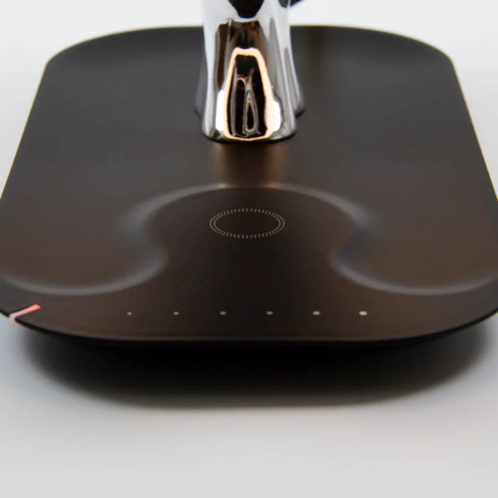 Wireless charging pad detail on smart lamp base with touch controls and USB port