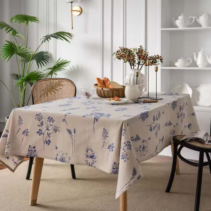 Scandinavian cotton linen tablecloth with blue floral print, styled on a dining table with modern decor.
