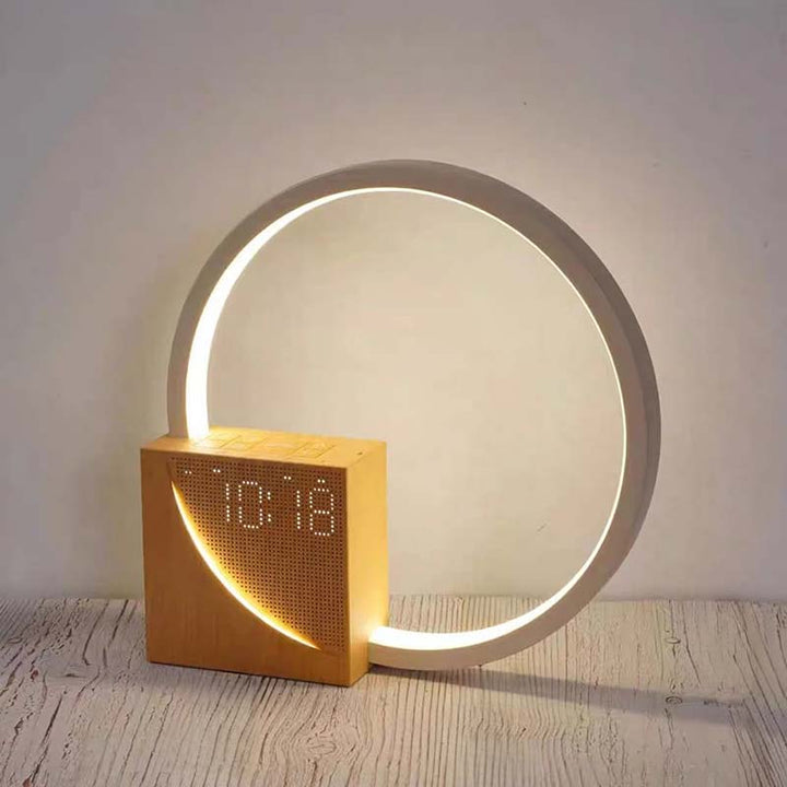 Wooden digital clock with a circular light fixture on a wooden surface.