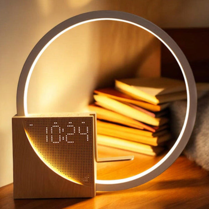 Modern clock with circular light feature on a shelf with books