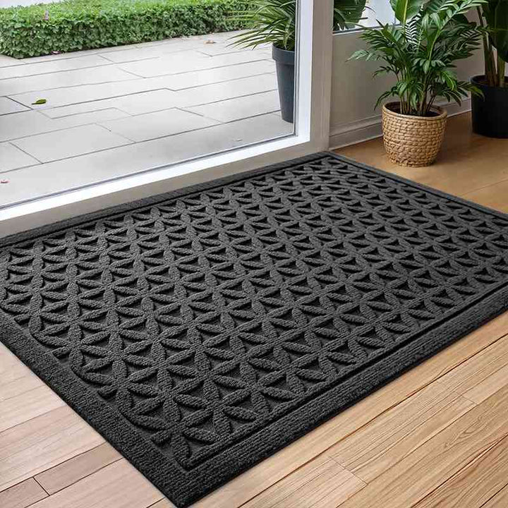 Black Geometry minimalist door mat, a polyester rug designed to trap dirt and absorb water at entrances.