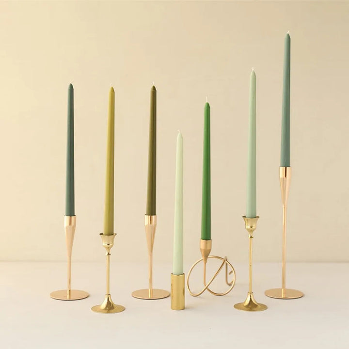 Green gradient wax taper candles in gold holders for dining table or wedding décor